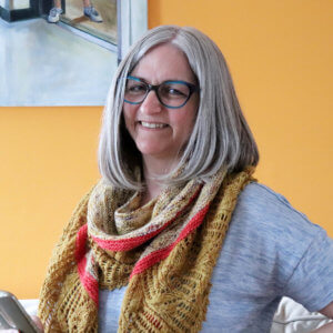 Brenda Schack smiling and wearing her pattern, the Kimono Moon Shawl.