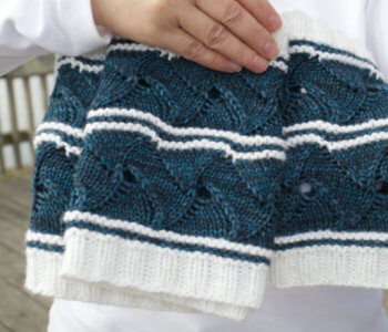 A close up of the blue and white yarn that makes up the lacy waves of the Swirling Seas Infinity Cowl